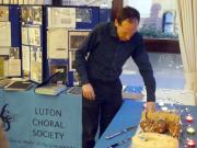 Cutting the Cake with Archive Display Behind